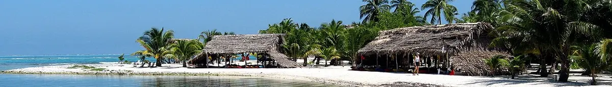 Belize Caye with beach huts and palm trees